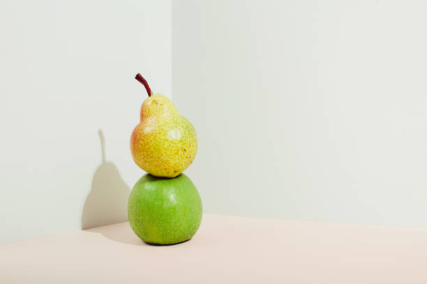 istock Icometric view of pears and apples in sunlight. Modern composition 1303226455