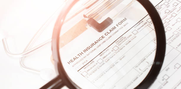 Health Insurance Claim Form 1500. Individual medical health insurance policy with stethoscope and magnifier stock photo