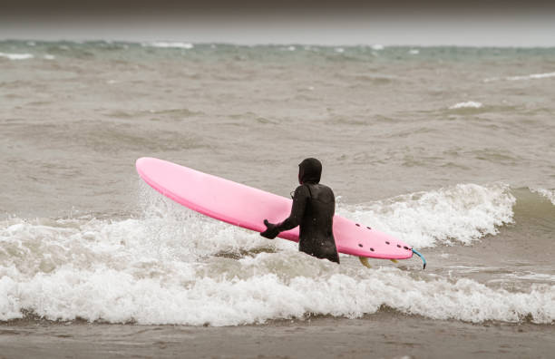 istock Young woman during winter surf 1303228783