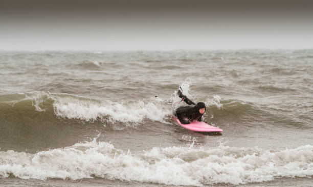 istock Young woman during winter surf 1303228786