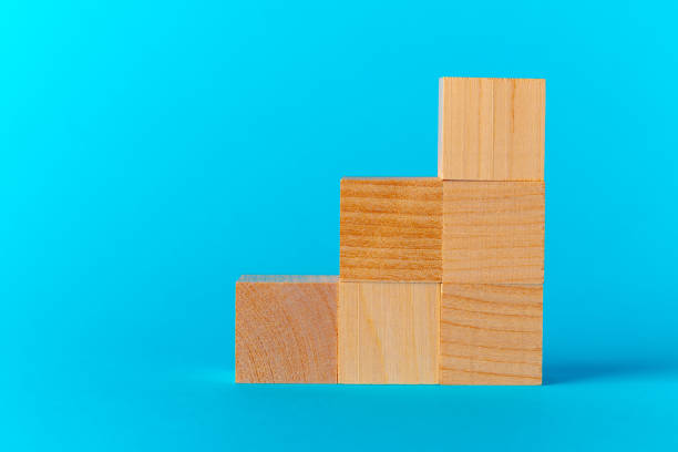 istock Toy wooden blocks on blue background front view 1303230190