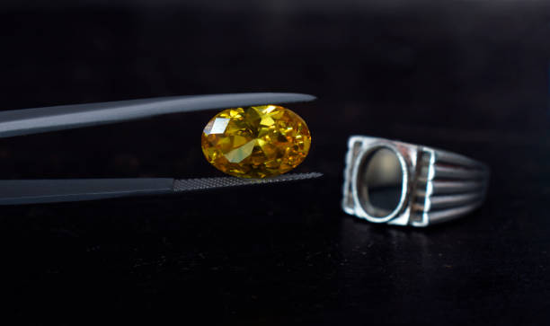 istock Gold ring decorated with yellow gemstone 1303234808