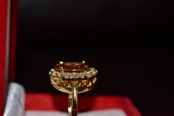istock Gold ring decorated with yellow gemstone 1303235488