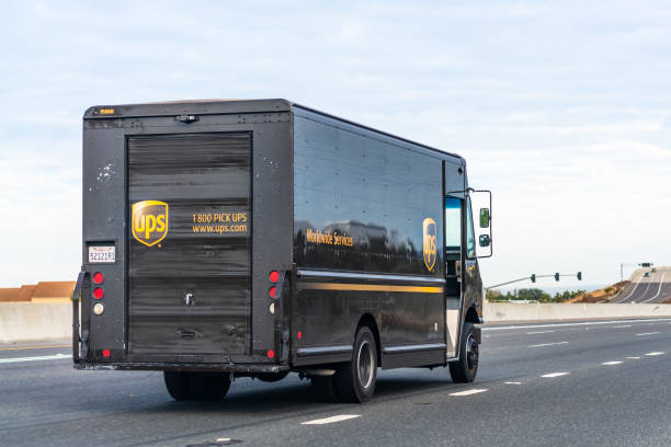 véhicule ups (united parcel service) effectuant des livraisons - united parcel service truck shipping delivering photos et images de collection