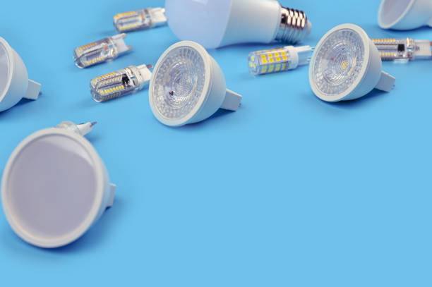 istock Several LED bulb on blue background. Saving energy concept. Ftat lay, top view, copy space. Bulbs for ceiling lights. 1303238970