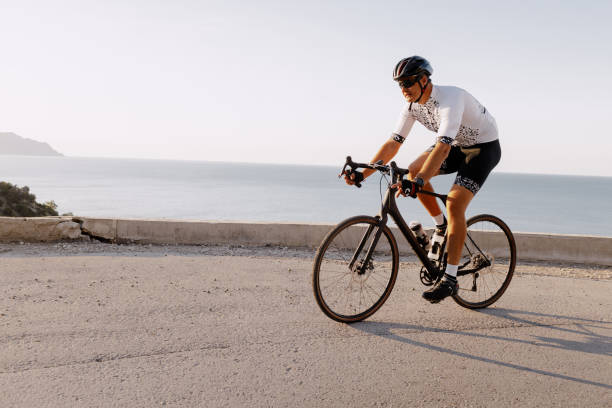 istock Professional road bicycle racer in action on mountain road 1303239689