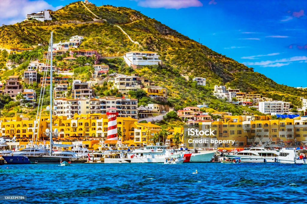 Lighthouse Yachts Boats Marina Central Stores Cabo San Lucas Mexico Colorful Lighthouse Marina Boats Yachts Harbor Water Reflection Stores Cabo San Lucas Baja Mexico.  Los Cabos has many boats and yachts Cabo San Lucas Stock Photo