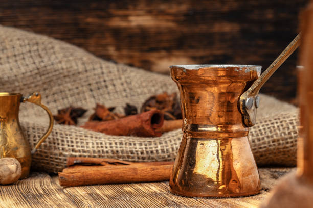istock Shiny copper turk with brewed coffee on brown wooden table 1303245333