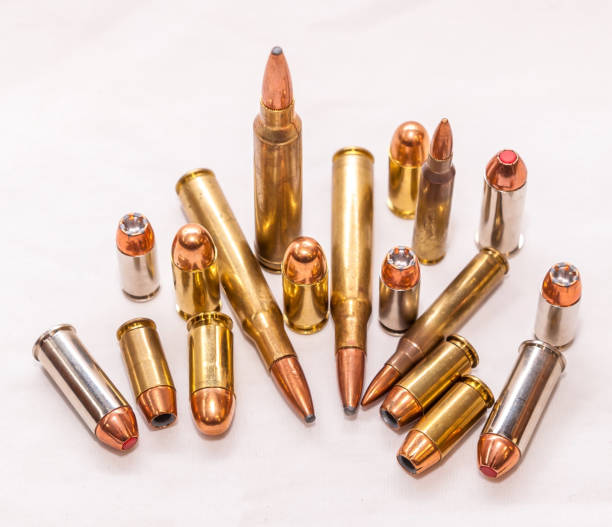 Different types of bullets on a white background Different bullets for handguns and rifles in 40 caliber, 9mm and 223 caliber on a white background ammunition stock pictures, royalty-free photos & images