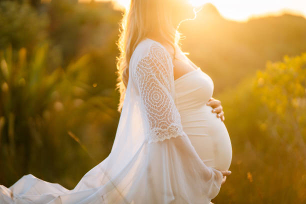 istock Pregnant woman out in summer. 1303249241