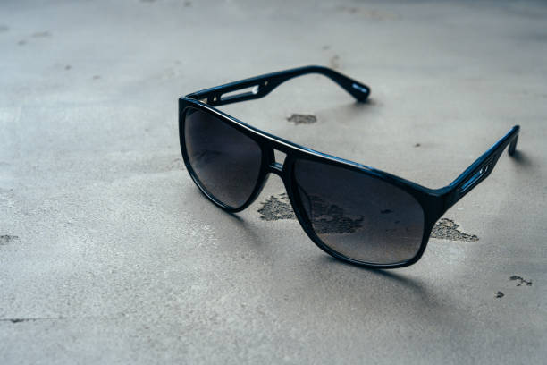 istock Dark male sunglasses on grey concrete surface 1303251108