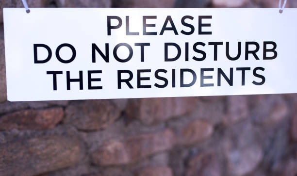 istock White Sign Reading: PLEASE DO NOT DISTURB THE RESIDENTS 1303251715