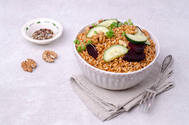 Wheat with vegetables Wheat with vegetables in a ceramic bowl on a cement background. Selective focus. kosher starter recipes stock pictures, royalty-free photos & images