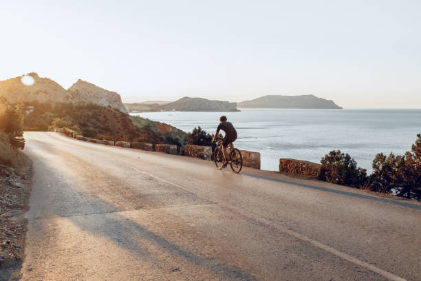 istock Cyclist riding on his bicycle at coastal road 1303256439