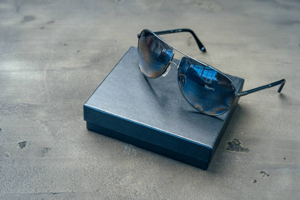 istock New dark aviator glasses on grey concrete background 1303256557