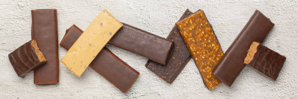 istock Whey protein powder in measuring scoop and different energy protein bar on grey background. 1303258224