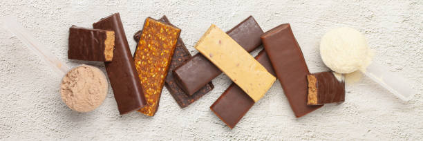 istock Whey protein powder in measuring scoop and different energy protein bar on grey background. 1303258228