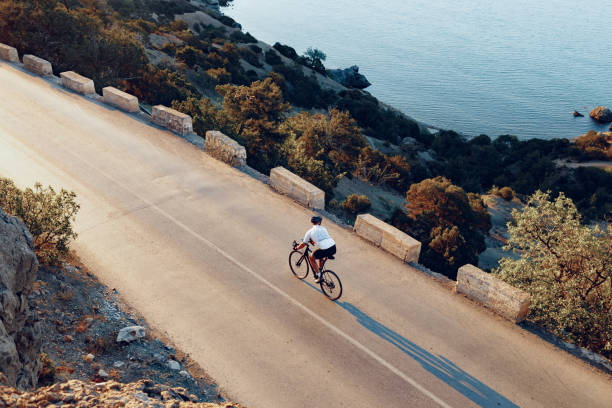 istock Cyclist riding on his bicycle at coastal road 1303259280