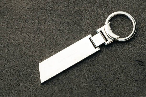 istock Metal key pendant on dark concrete background 1303260009