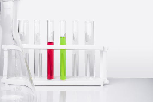 Water quality monitoring in chemical laboratories. The red chemical in the test tube has a high PH ranges value (Acids Strength). The green chemicals have a medium PH value (Neutral).