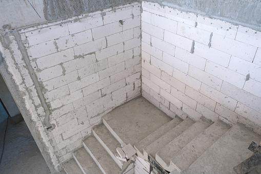 Install stair concrete in new house structure use lightweight cement brick and white lintel plaster to joint for reinforce in site.