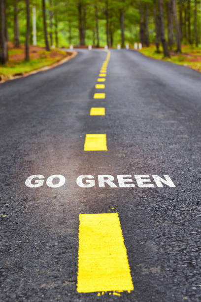 istock Journey to go green on asphalt road surface on nature background 1303268670