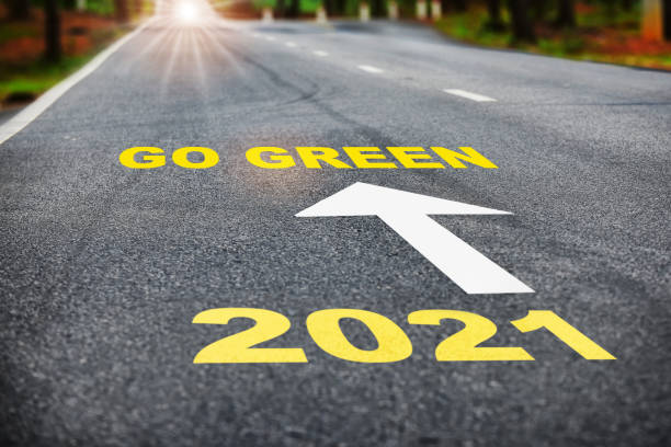 istock 2021 go green on asphalt road surface with marking lines 1303268679