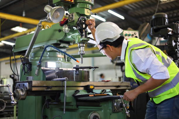 istock Asian mechanic worker in safety hard hat and reflective cloth is working with lathe machine in the factory 1303268698