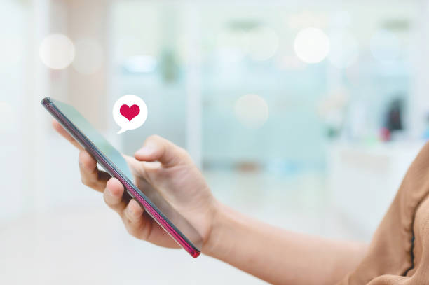 istock Hand using smartphone look message from lovers. She sending a message encouraging to boyfriend 1303268734
