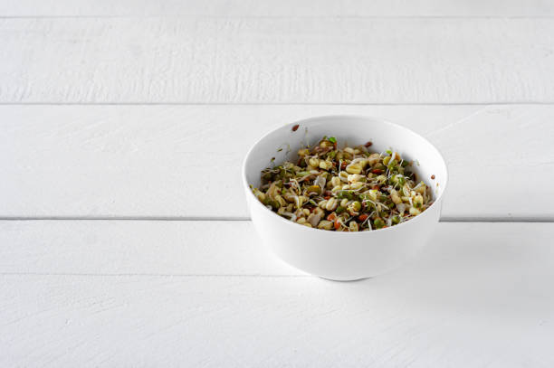 istock Sprouted mung beans in a bowl on white table. Healthy concept, macrobiotic food. 1303272249