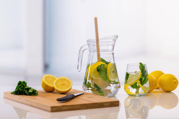 istock Jar and glass with cutting table and lemons 1303272377