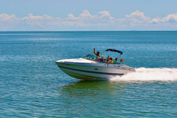 Reedville, Virginia / USA - June 21, 2020: A family enjoys power boating on the Chesapeake Bay on a hot summer day afternoon.
