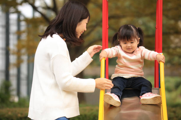 istock Parents and children playing on the slide 1303273214