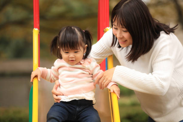 istock Parents and children playing on the slide 1303273226