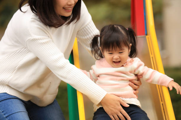 istock Parents and children playing on the slide 1303273271