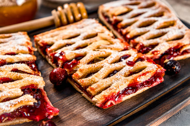 Three pieces sweet pie with berries and powdered sugar, close up, soft focus