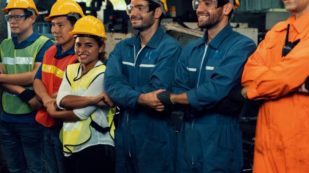 istock Skillful worker stand together showing teamwork in the factory . 1303274886