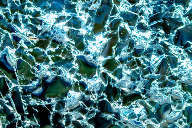 istock Transparent ice cracked crystals with bubbles texture background. Cold winter ice texture 1303278501