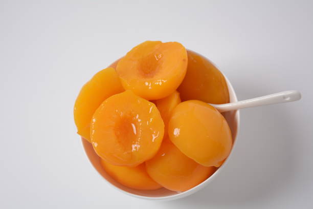 istock Sweet canned peaches in the ceramic bowl 1303278557