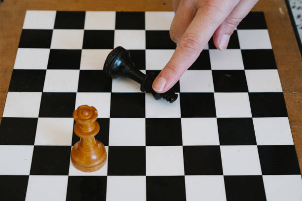 istock chessboard with the king killed by the queen 1303279781