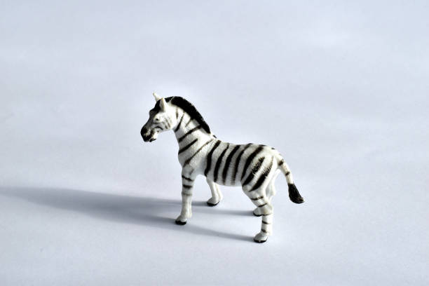 istock Children's toy. Zebra on white. Made of plastic. Side view. 1303281633