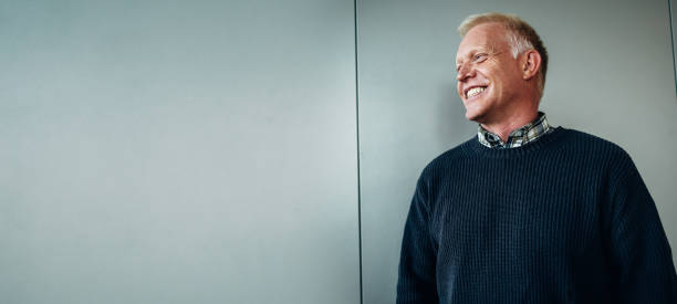 istock Senior businessman looking away and smiling 1303282601