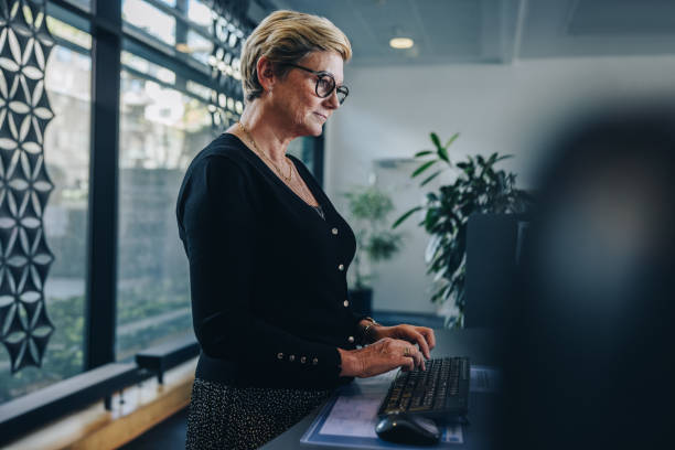 istock Senior businesswoman working in office 1303282653