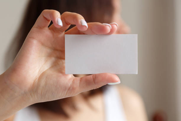 istock Man holding a white business card in his hand 1303282925