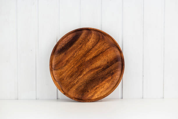 istock Wooden dish on white wall background 1303284668