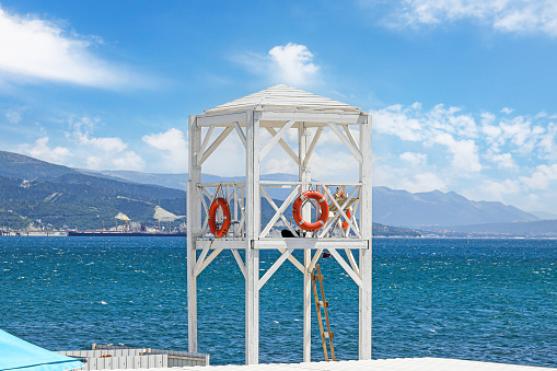 Lifeguard tower with lifebuoy on the city beach.
