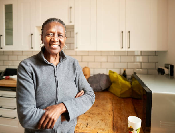 istock Happy senior woman in her kitchen 1303288532