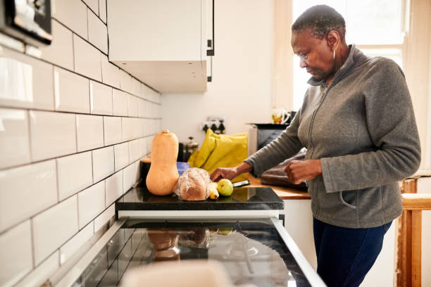 istock Senior woman working in the kitchen 1303288555