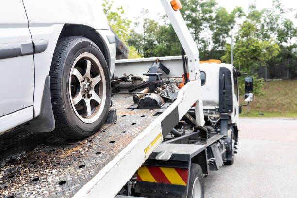 istock Cable attached to broken down car being pulled onto tow truck 1303290359