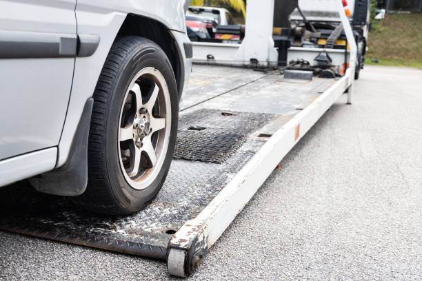 istock Cable attached to broken down car being pulled onto tow truck 1303290380